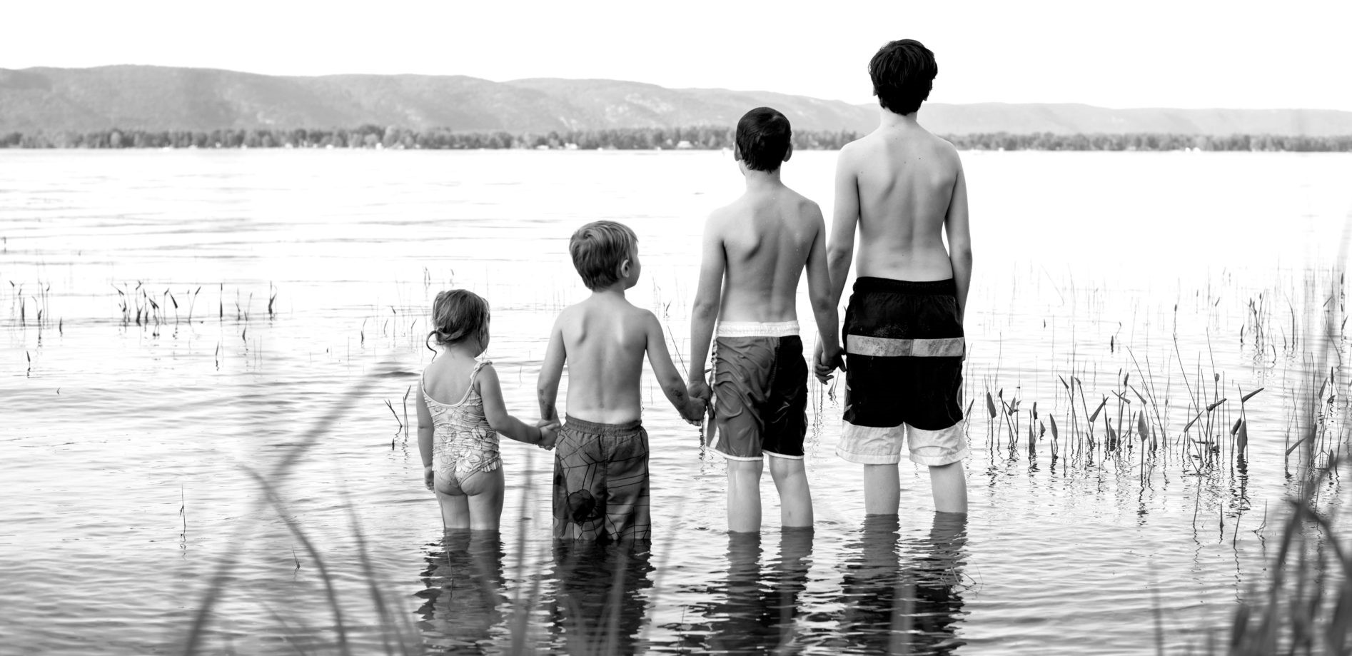 picture of 4 kids at a lake